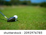 Small photo of Close up of Asian man golfer hand holding golf club hitting golf ball on the green at golf course. Healthy male enjoy outdoor lifestyle activity sport golfing at country club on summer vacation