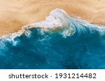 Blue ocean and clean sandy beach. Beautiful sea and wild beach with yellow sand. Blue ocean wave on a sandy beach. Top view of the tropical beach. Paradise island. Copy space