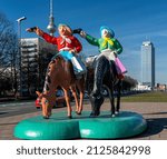 Small photo of berlin, 2022, february, 13, kitschy plastic figures stand on the median of Karl-Marx-Allee