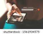 Love loading progress, Finger of woman pushing heart icon on screen in mobile smartphone application. Online dating app, valentine's day concept. Mockup website.