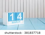 March 14th. Image of march 14 wooden color calendar with flower on white background.  Spring day.  Commonwealth and International ? Day