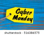 Cyber Monday sales tag. Yellow color tags on blue wooden background
