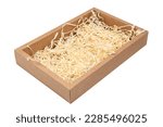 Wooden box with wood shavings straw chips fillings isolated on white.