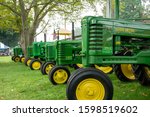 Small photo of Kinzers, Pennsylvania - August 14, 2019: Row of John Deere tractors at the Rough and Tumble Thresherman's Renuion in Kinzers.