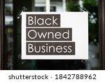 Black owned business sign attached on the window