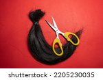 Small photo of A lock of hair and scissors