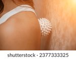Small photo of Athletic slim caucasian woman doing thigh self-massage with a massage ball indoors. Self-isolating massage