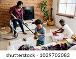 Black family cleaning the house together