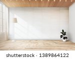 Lamp and a plant in an empty room wall mockup