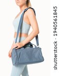 Small photo of Sporty woman carrying blue duffle bag gym essentials studio shoot