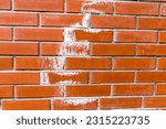 Efflorescence on new red bricks wall