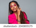 Fashion Portrait Black Woman in Pink clothes. Fashion Makeup curly hair and braids, lip gloss. Luxury Fashion model African American posing in studio, pink wall. Beautiful black woman looking down    