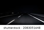 Small photo of POV view of car driving on road of highway at night in Spain. Drive on an empty road in the dark evening. A car drives on a freeway. Asphalt with white line at new road.