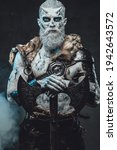 Small photo of Nordic warlike undead with hatchet in smokey background