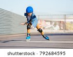 Boy riding on roller skates at...
