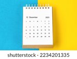 December 2023 Monthly desk calendar for 2023 year on blue and yellow background.