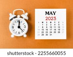May 2023 Monthly calendar for the organizer to plan 2023 year with alarm clock on yellow background.