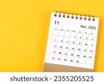 Small photo of November 2023 Monthly desk calendar for 2023 year on yellow background.