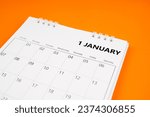 Small photo of January 2024 month calendar on orange color cover background. Monthly calendar concepts.