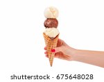 Chocolate and vanilla ice cream cone on white background. Hand holding ice cream cone. 