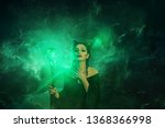 Small photo of mysterious dark elf got terrible curse, charming girl with horns on head. glowing sparkling magic staff in hands damned lady. storm green electric fire creative art. character Maleficent Ancient mage