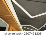 Small photo of Close up on holders of automatic sliding canopy retractable roof system, patio awning for sunshade of a house.