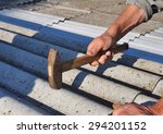 stock-photo-roofing-repair-dangerous-asbestos-old-roof-tiles-roofer-installs-asbestos-roof-shingles-closeup-294201152.jpg