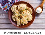 Dumplings, filled with cabbage. Varenyky, vareniki, pierogi, pyrohy - dumplings with filling. View from above, top studio shot