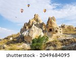 Hot air balloons flying over the cave houses of the Goreme open air museum in Cappadocia, Turkey