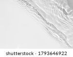Small photo of Blurred desaturated transparent clear calm water surface texture with splashes and bubbles. Trendy abstract nature background. White-grey water waves in sunlight.