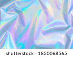 De-focused abstract Modern pastel colored holographic background in 80s style. Crumpled iridescent foil textile real texture. Synthwave. Vaporwave style. Retrowave, retro futurism, webpunk