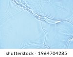 Small photo of De-focused blurred transparent blue colored clear calm water surface texture with splashes and bubbles. Trendy abstract nature background. Water waves in sunlight with copy space.
