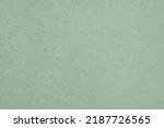 Small photo of Saturated pastel gray green colored low contrast Concrete textured background. Empty colourful wall texture with copy space for text overlay and mockups. 2023, 2024 color trend