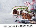 Christmas fruit cake, pudding on white plate. Traditional New Year dessert. Copy space. 
