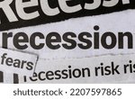 Small photo of Economic recession dominating headline business news in major newspapers. Clippings of newspaper headline titles reporting on economic recession. Closeup macro view.