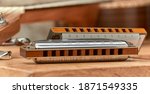 Small photo of Harmonica Blues - blues diatonic harp for playing country and Western.On light background.