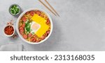 Small photo of Ramen Noodles with Sausages, Egg, Melted Cheese and Scallion, Microwave Shin Ramyeon or Ramyun,Korean Noodles on Bright Background