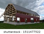 Small photo of Barn with gambrel roof under construction