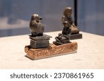 Small photo of figurine of a noble Egyptian man at a meeting with god Khonsu in the guise of an orangutan