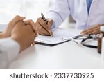 Small photo of Doctor diagnosing a woman's illness in a hospital examination room, disease treatment from specialists. Medical treatment and health consultation. General health checkups and women's health problems.