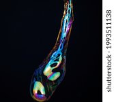 Small photo of Amorphous and colorful isolated soap bubble with black background.