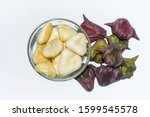 Small photo of Heap of peeled water caltrop or water chestnut fruit in a glass bowl on white background.Top view.