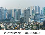 Small photo of Metro Manila, Philippines - April 2021: Ortigas and Boni skyline contrast a dense and less affluent district. During a hazy afternoon.