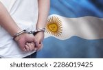 Small photo of A man getting under arrest in Argentina. Concept of being handcuffed, detained, incarcerated and jailed in said country. National law enforcement concept.