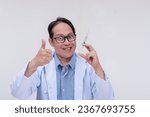 Small photo of A deranged doctor making the thumbs up sign while eagerly holding a syringe and with an evil grin. Isolated on a white background.