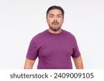 Small photo of Facial reaction of a middle aged man looking perplexed or flummoxed. Looking dazed, confused at the camera. Experiencing brain fog. Isolated on a white background.