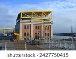 Small photo of Ostend, West-Flanders, Belgium - February 17, 2024: Entrepot-Stapelhuis shooting from inside a tram on a red brick bonded warehouse with yellow steel roof structure