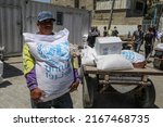 Small photo of Palestinians receive food rations from the United Nations Relief and Works Agency (UNRWA) warehouse the Khan Yunis refugee camp in the southern Gaza Strip, on June 14, 2022.