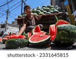 Small photo of A great turnout of Palestinians to buy watermelon and cold "icy" drink in order to cool themselves, due to the extreme hot weather hitting the area, in the market in Gaza Strip, on July 14, 2023.