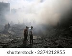 Small photo of Palestinians look for survivors after an Israeli airstrike in Rafah refugee camp, southern Gaza Strip, on October 12 2023.